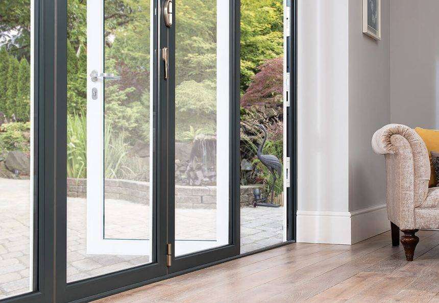 A modern dual-color aluminium door with a sleek black exterior and a warm wood-finish interior, enhancing the contemporary design of a luxury home entrance.