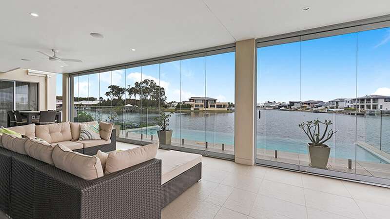 Frameless bi-fold doors opening to a garden