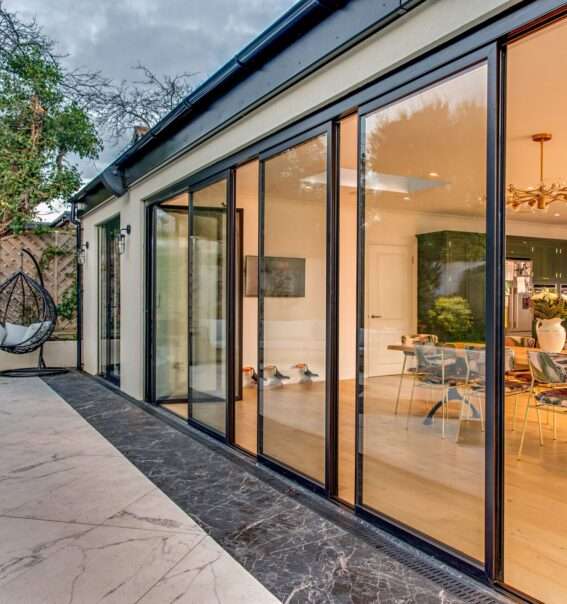 Ultra slim bi-fold glass doors installed in a contemporary living room