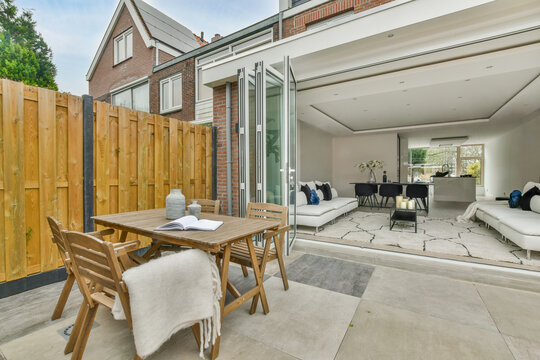 A foldable sliding door connecting the living room to an outdoor patio.