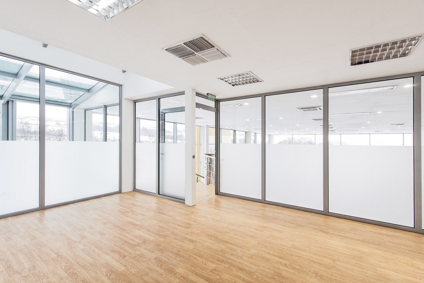 Separate rooms with elegant frameless glass partitions for a modern home aesthetic.