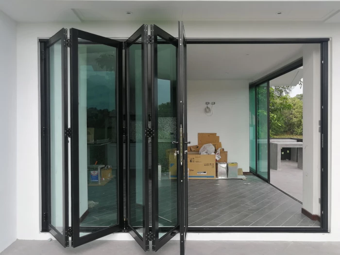 Automatic bi-folding glass doors opening onto a patio in a Dubai residence
