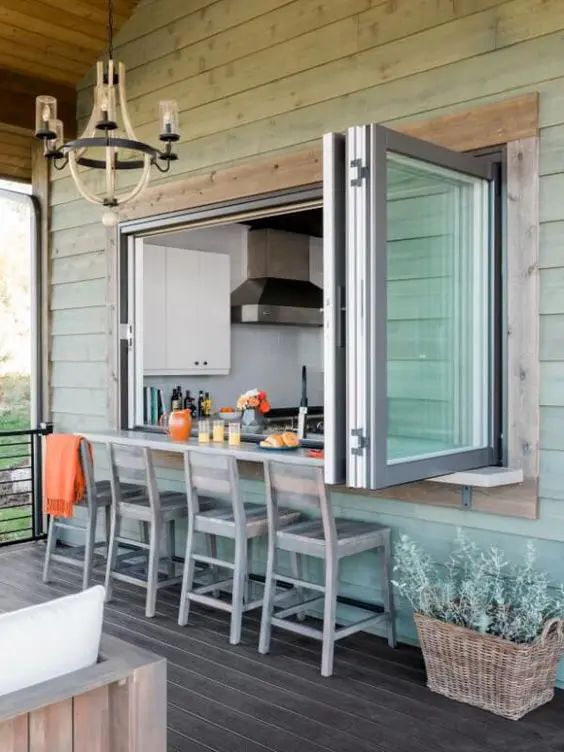Folding window doors in a modern kitchen opening to a balcony in Dubai.